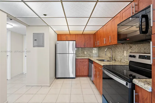 a kitchen with granite countertop a sink and cabinets