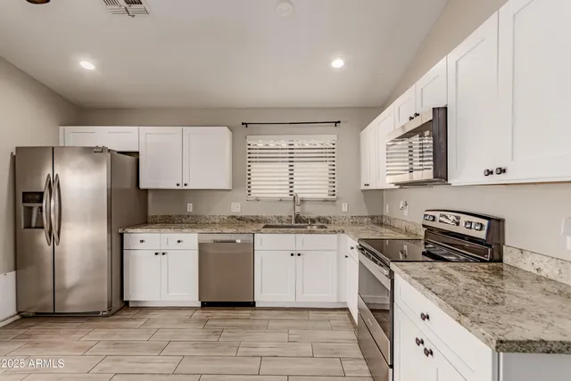 a kitchen with a sink stove and refrigerator