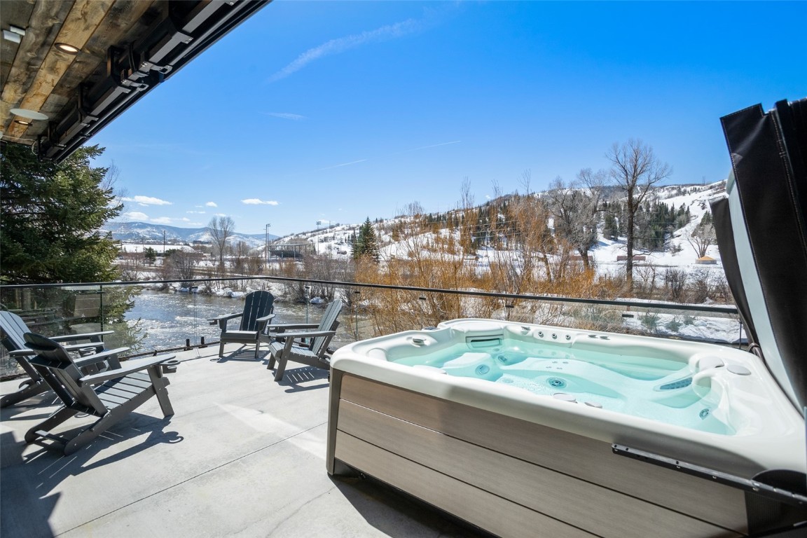 655 Yampa Street, Unit R1 Steamboat Springs, CO 80487 - Photo 12 of 49 a view of swimming pool with outdoor seating and city view