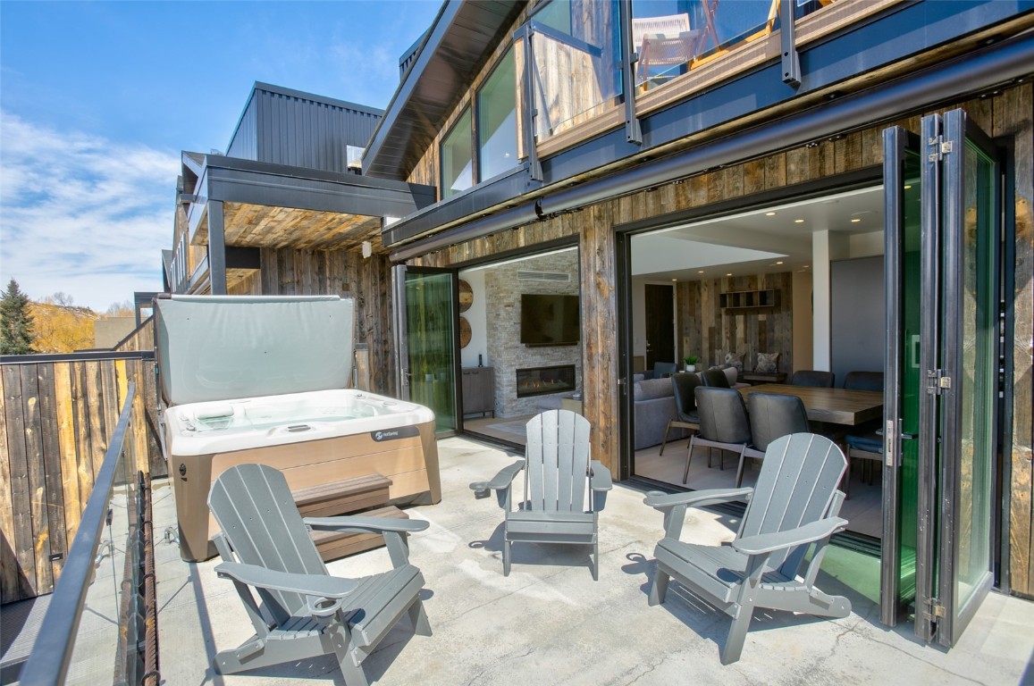 655 Yampa Street, Unit R1 Steamboat Springs, CO 80487 - Photo 15 of 49 a view of a patio with a table and chairs in front of it