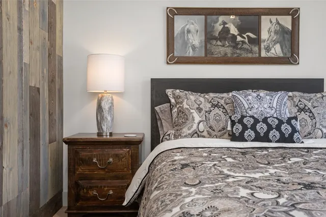 a bedroom with a large bed and a window