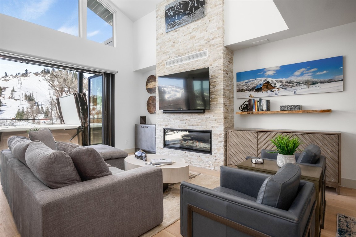 655 Yampa Street, Unit R1 Steamboat Springs, CO 80487 - Photo 2 of 49 a living room with furniture a flat screen tv and a fireplace