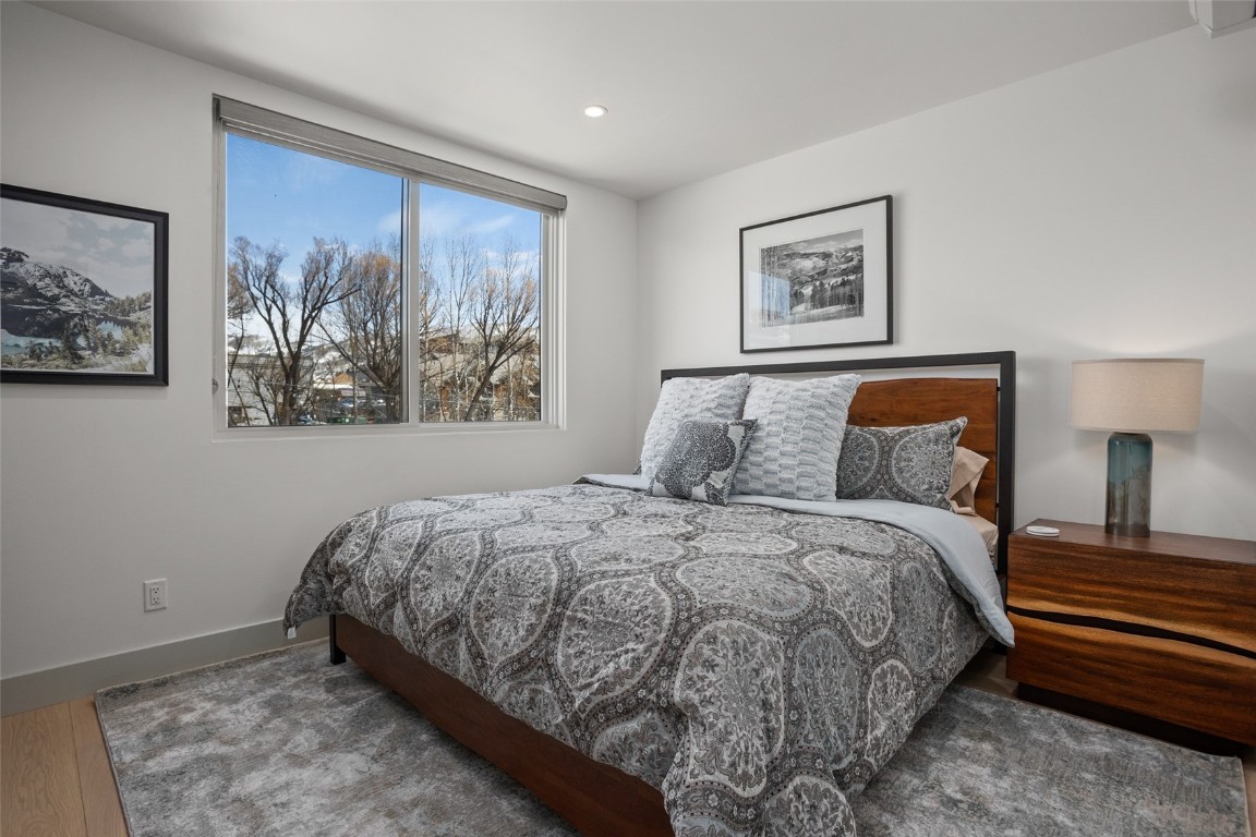 655 Yampa Street, Unit R1 Steamboat Springs, CO 80487 - Photo 22 of 49 a bedroom with a bed and painting on the wall