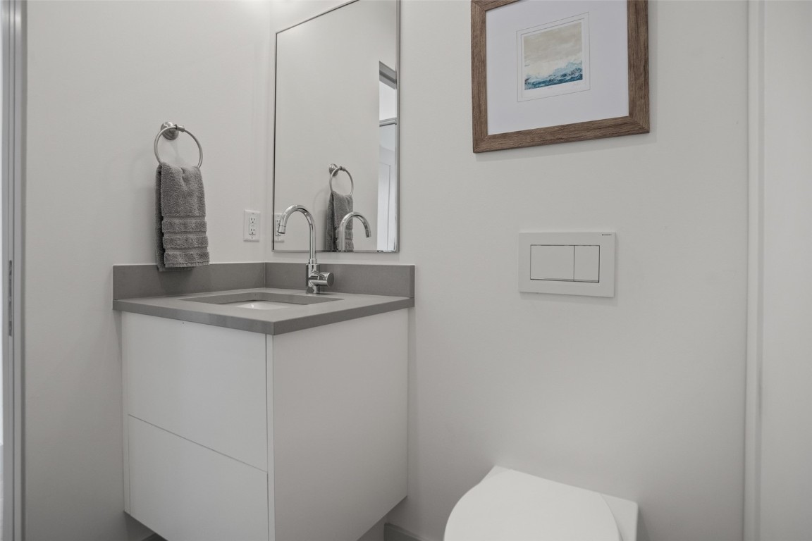 655 Yampa Street, Unit R1 Steamboat Springs, CO 80487 - Photo 27 of 49 a bathroom with a toilet sink and mirror
