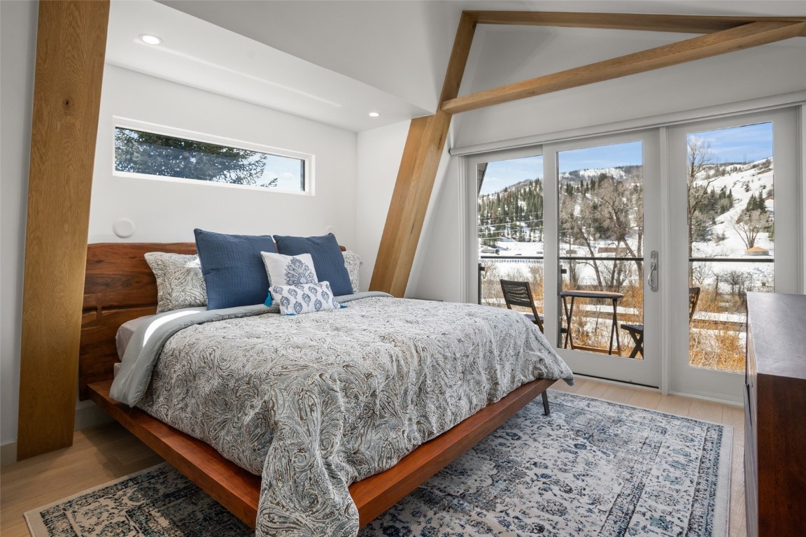 655 Yampa Street, Unit R1 Steamboat Springs, CO 80487 - Photo 30 of 49 a bedroom with a large bed and a large window