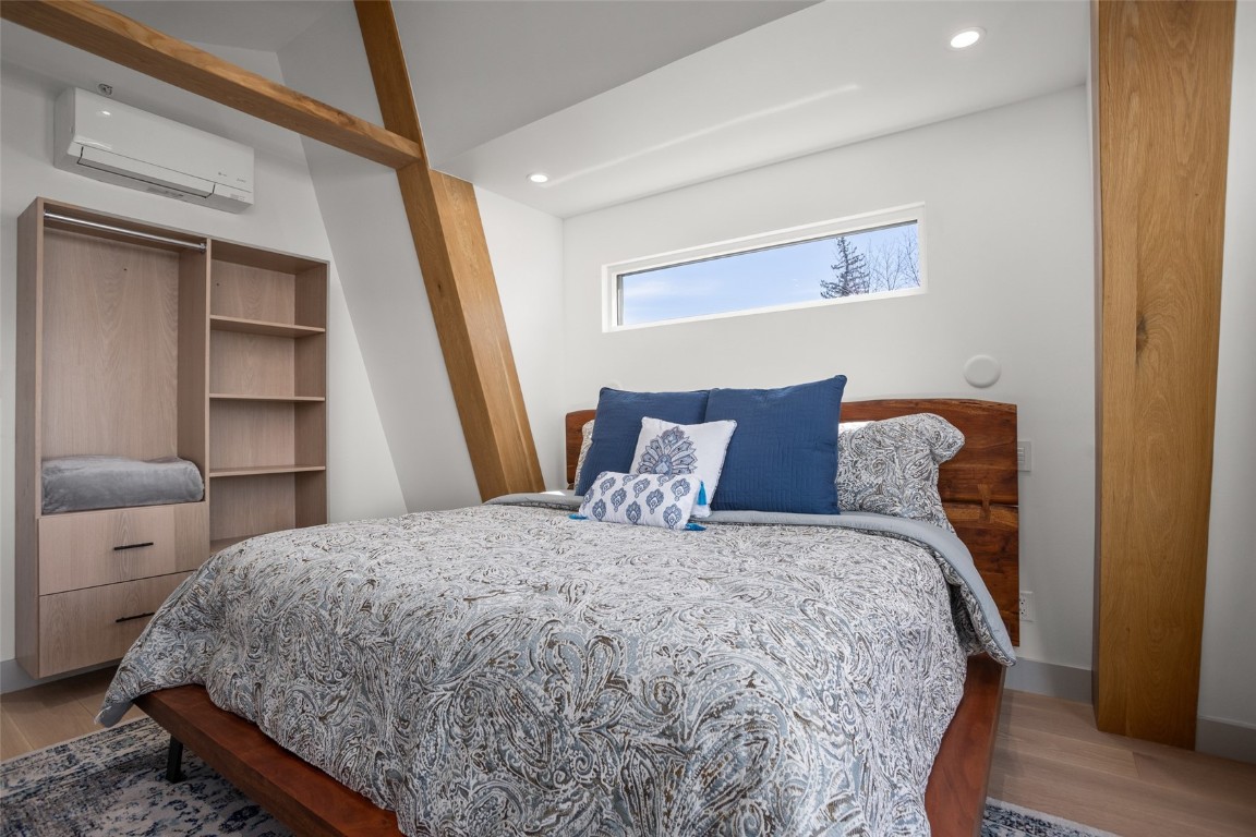 655 Yampa Street, Unit R1 Steamboat Springs, CO 80487 - Photo 32 of 49 a large bed sitting in a bedroom next to a small yard