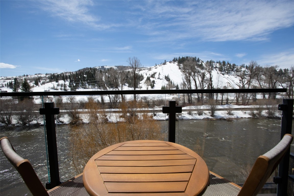 655 Yampa Street, Unit R1 Steamboat Springs, CO 80487 - Photo 33 of 49 a view of a lake from a balcony