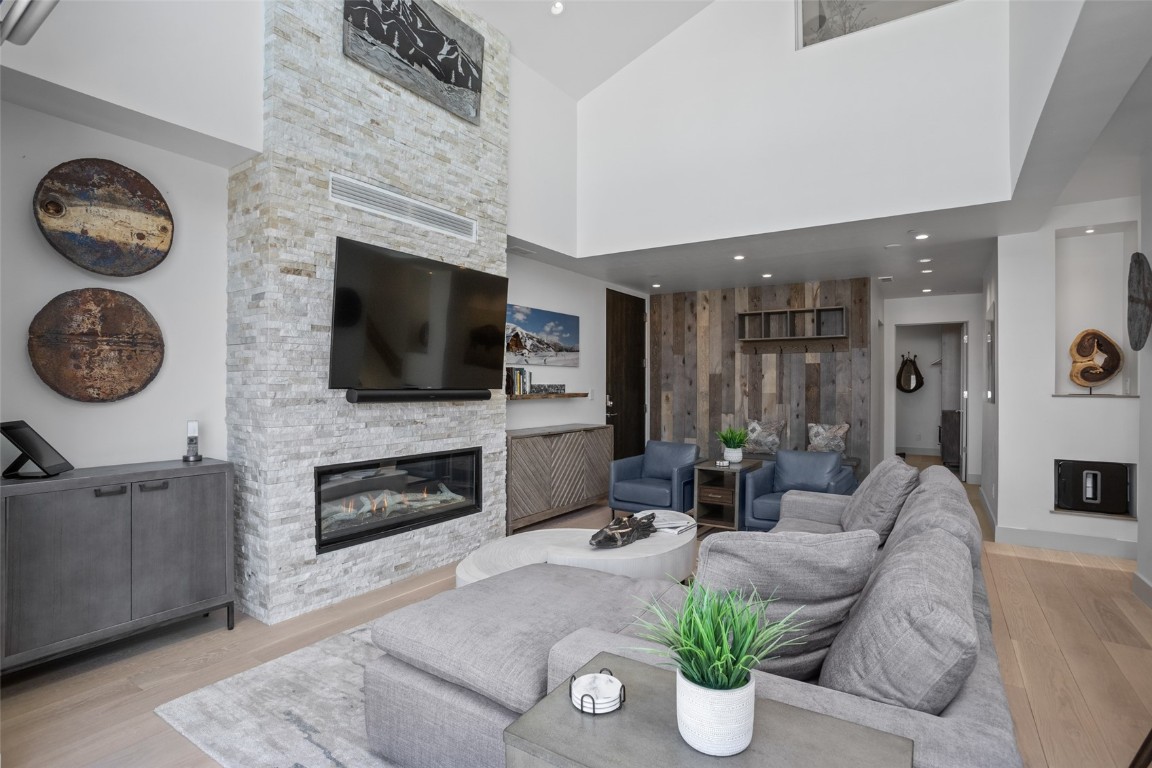 655 Yampa Street, Unit R1 Steamboat Springs, CO 80487 - Photo 4 of 49 a living room with furniture a flat screen tv and a fireplace