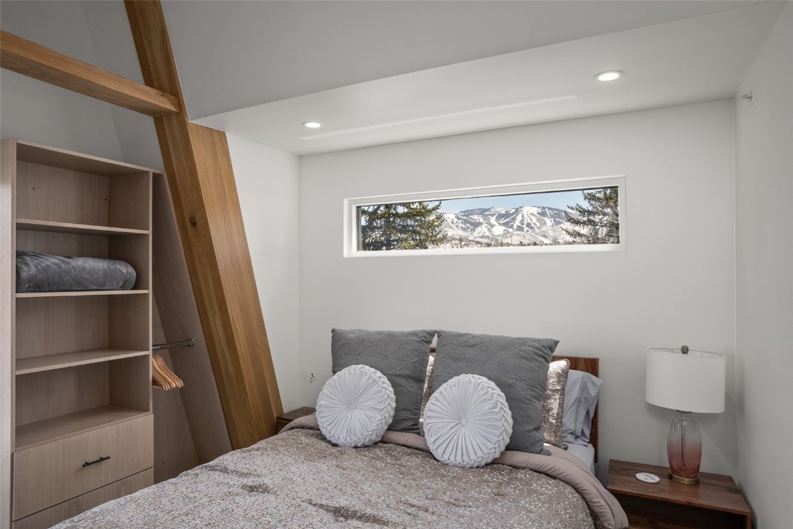 655 Yampa Street, Unit R1 Steamboat Springs, CO 80487 - Photo 42 of 49 a large bed sitting in a bedroom next to a cabinet