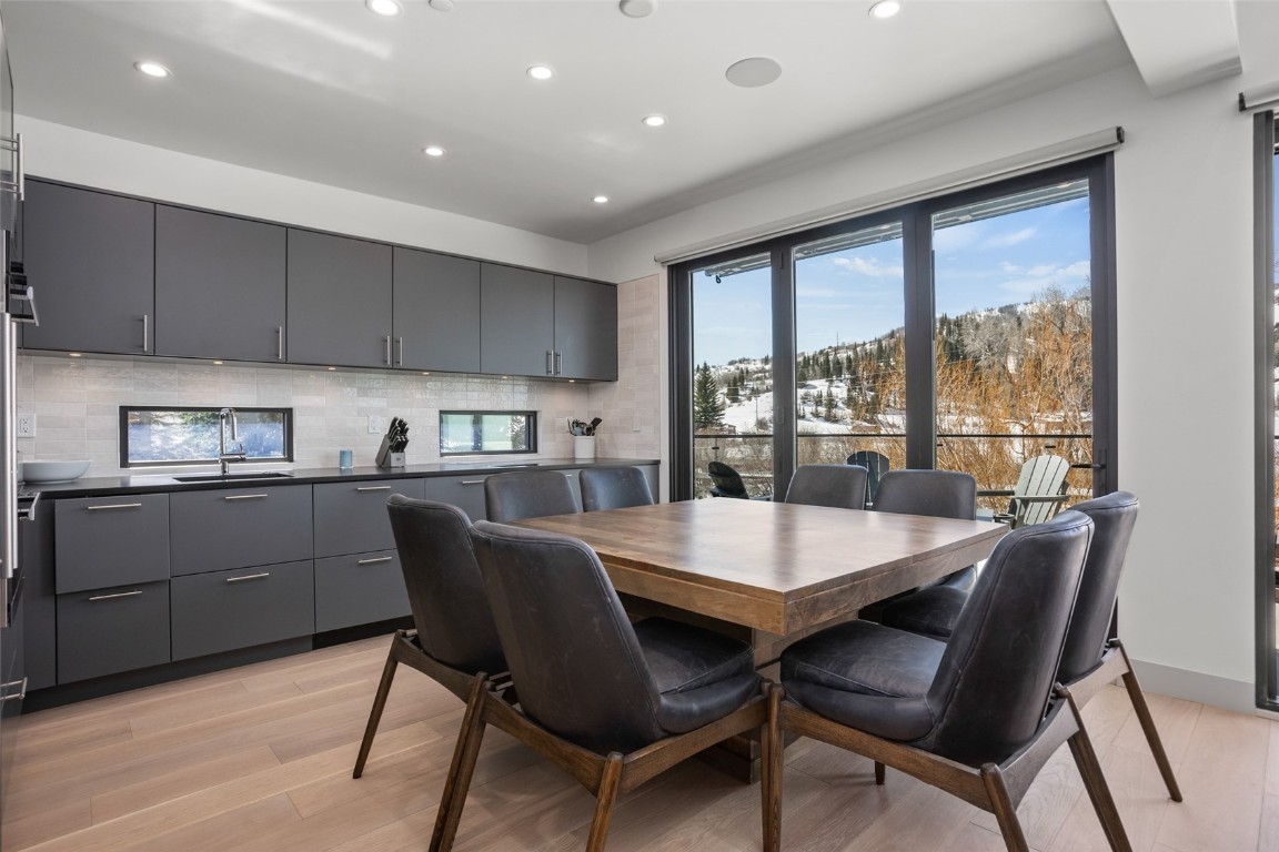 655 Yampa Street, Unit R1 Steamboat Springs, CO 80487 - Photo 8 of 49 a kitchen with a dining table chairs and refrigerator