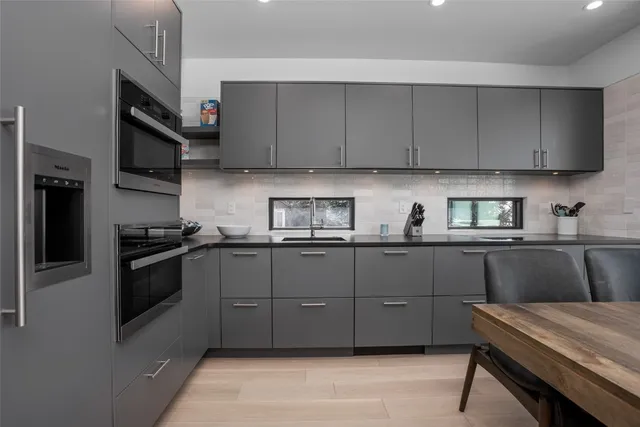 a kitchen with a sink and stainless steel appliances