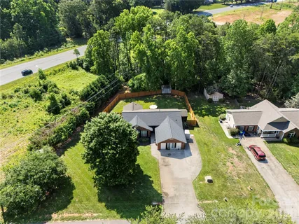 an aerial view of a house with yard swimming pool and outdoor seating