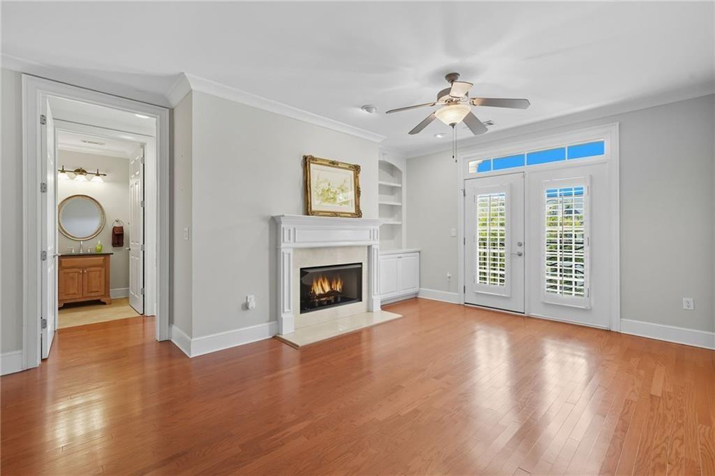 4950 Ivy Ridge Drive Southeast, Unit 203 Atlanta, GA 30339 - Photo 15 of 39 a view of an empty room with chandelier fan and a fireplace