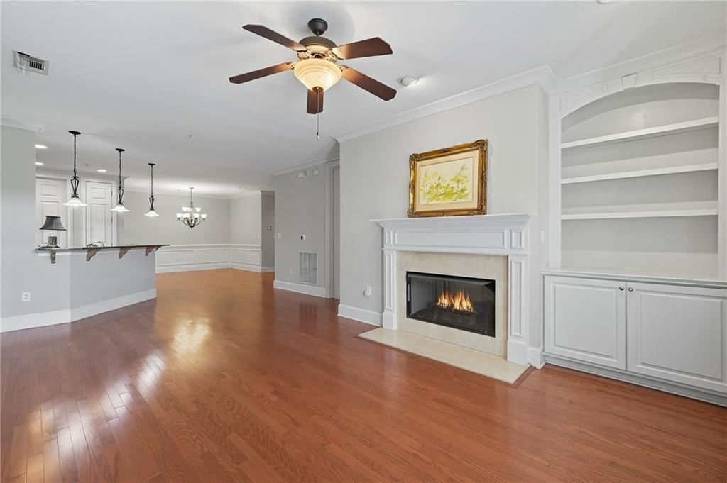4950 Ivy Ridge Drive Southeast, Unit 203 Atlanta, GA 30339 - Photo 17 of 39 a view of a kitchen with a fireplace a ceiling fan and wooden floor