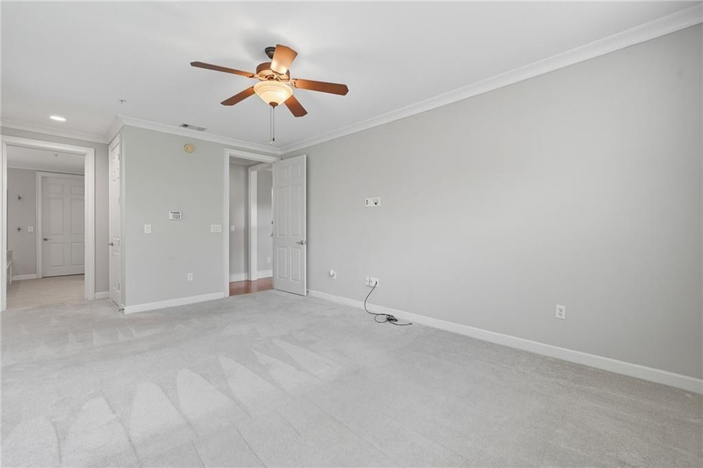 4950 Ivy Ridge Drive Southeast, Unit 203 Atlanta, GA 30339 - Photo 21 of 39 an empty room with ceiling fan and window