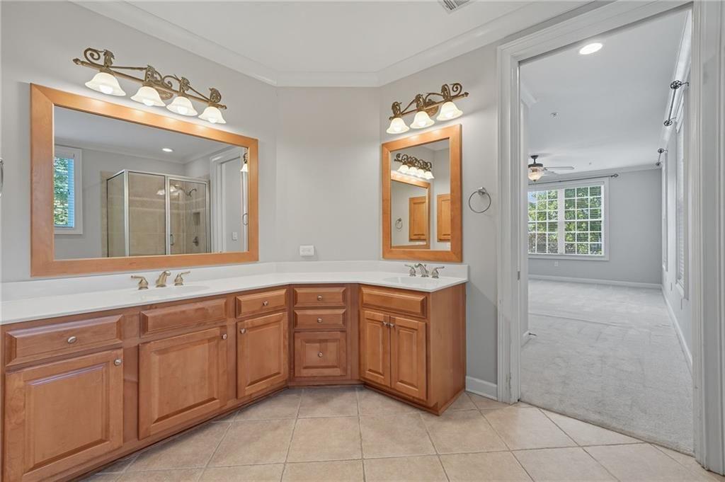 4950 Ivy Ridge Drive Southeast, Unit 203 Atlanta, GA 30339 - Photo 22 of 39 a spacious bathroom with a granite countertop sink a mirror and a
