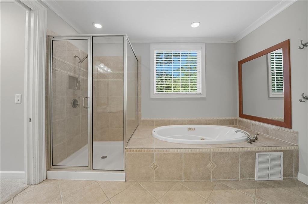 4950 Ivy Ridge Drive Southeast, Unit 203 Atlanta, GA 30339 - Photo 23 of 39 a bathroom with a tub shower and sink