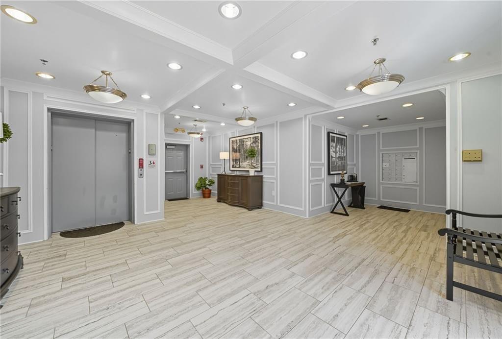 4950 Ivy Ridge Drive Southeast, Unit 203 Atlanta, GA 30339 - Photo 28 of 39 a view of an empty room and kitchen with furniture wooden floor and ceiling fan
