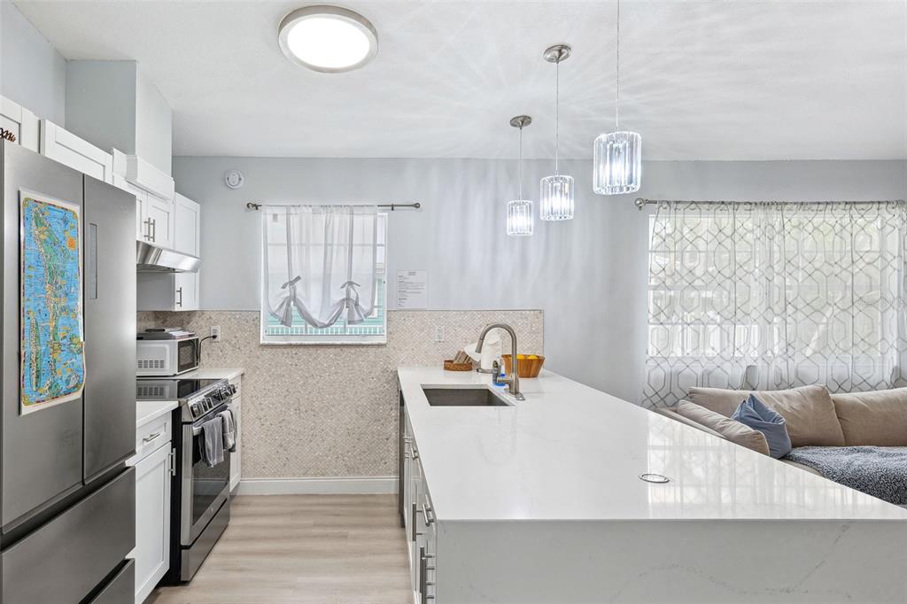 311 Poinsettia Road Anna Maria, FL 34216 - Photo 11 of 36 a bathroom with a sink a washer and dryer
