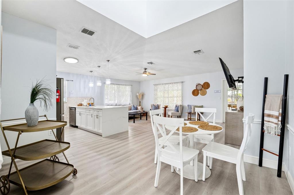 311 Poinsettia Road Anna Maria, FL 34216 - Photo 16 of 36 a view of a dining room with furniture and wooden floor