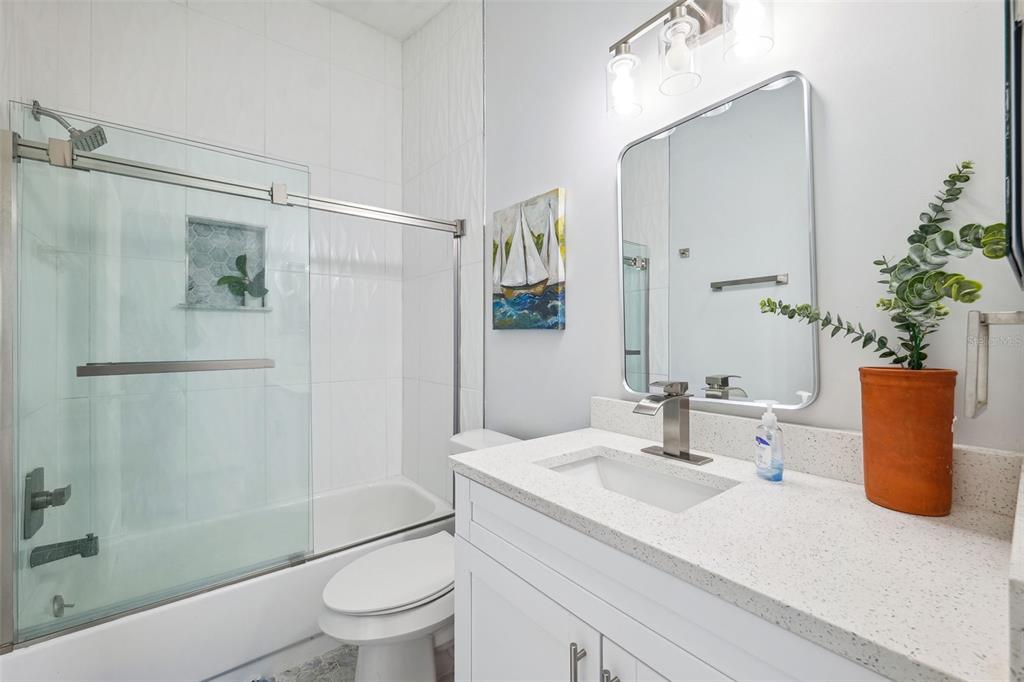 311 Poinsettia Road Anna Maria, FL 34216 - Photo 20 of 36 a bathroom with a granite countertop sink a toilet and shower