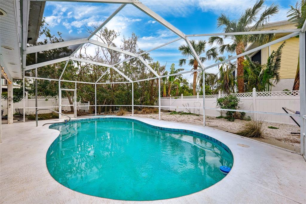 311 Poinsettia Road Anna Maria, FL 34216 - Photo 34 of 36 a view of a swimming pool with a patio