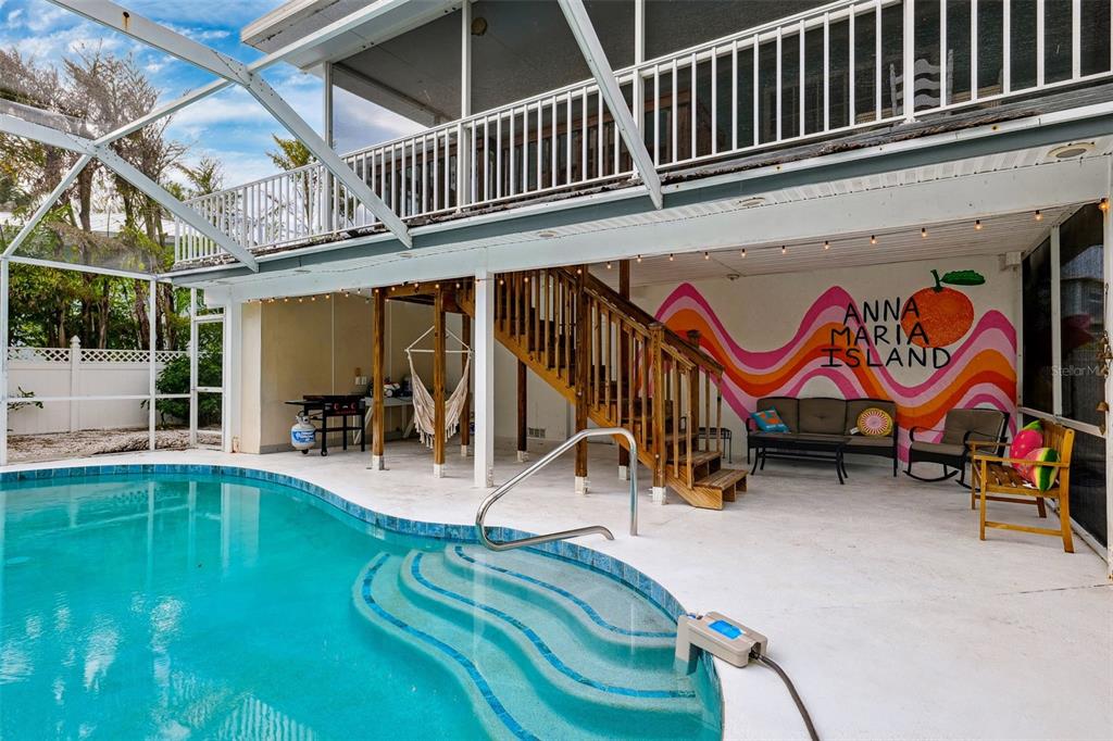 311 Poinsettia Road Anna Maria, FL 34216 - Photo 35 of 36 a view of a swimming pool with a bench in patio