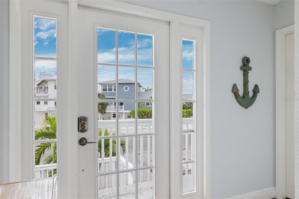 311 Poinsettia Road Anna Maria, FL 34216 - Photo 5 of 36 a view of a porch with a floor to ceiling window