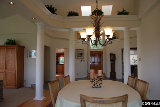 45 Rimfire Circle Reno, NV 89519 - Photo 2 of 9 a dining room with wooden floor a chandelier a wooden table and chairs