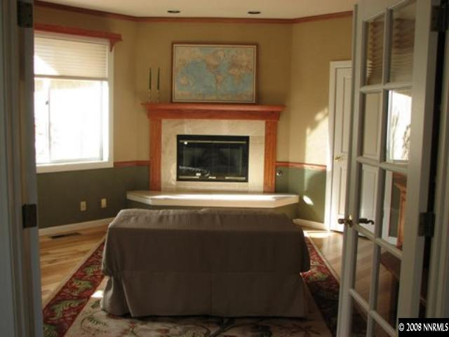 45 Rimfire Circle Reno, NV 89519 - Photo 4 of 9 a living room with a fireplace windows and a fireplace