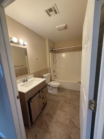 a bathroom with a sink mirror vanity and toilet