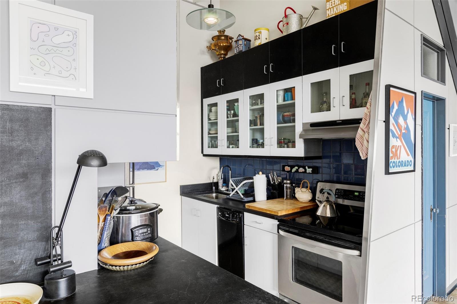 3309 Blake Street, Unit 207 Denver, CO 80205 - Photo 8 of 14 a kitchen with a sink and a stove