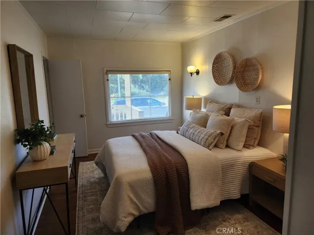 a view of a room that has a mirror and a wooden floor