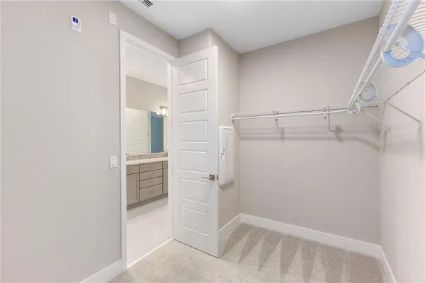 a view of walk in closet with empty racks