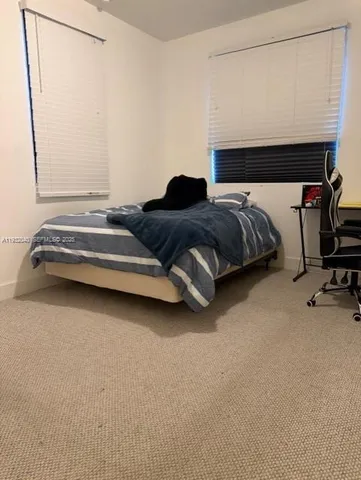 a bedroom with a bed and a mirror