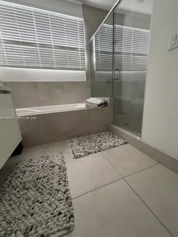 a bathroom with a bathtub and window