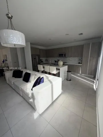 a living room with furniture a table and chairs