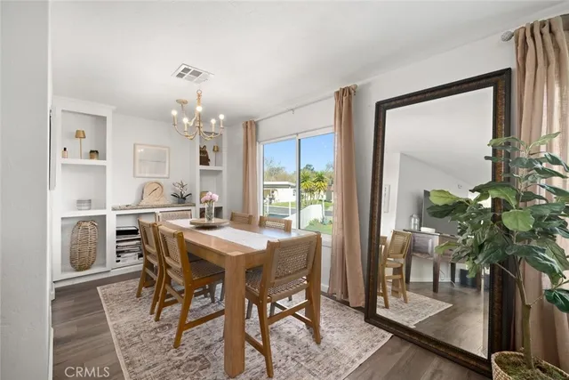 a view of a dining room with furniture and a potted plant