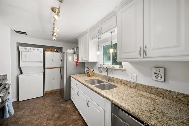 a kitchen with sink cabinets and refrigerator