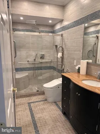 a bathroom with a double vanity sink toilet and shower