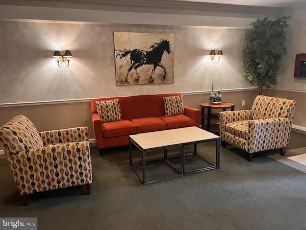 a living room with furniture and lamp