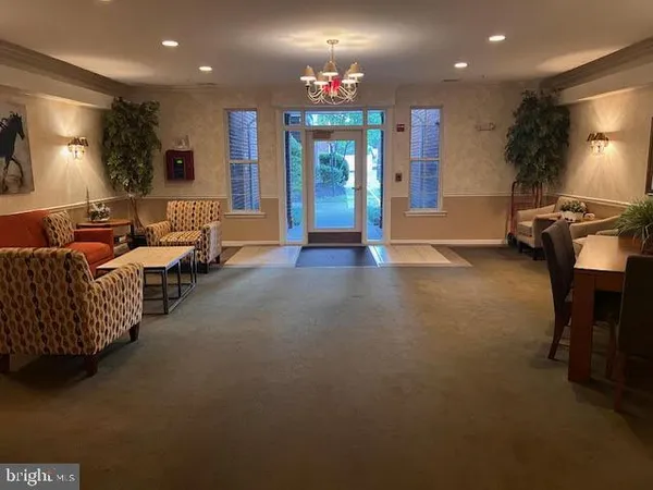 a living room with furniture and a chandelier