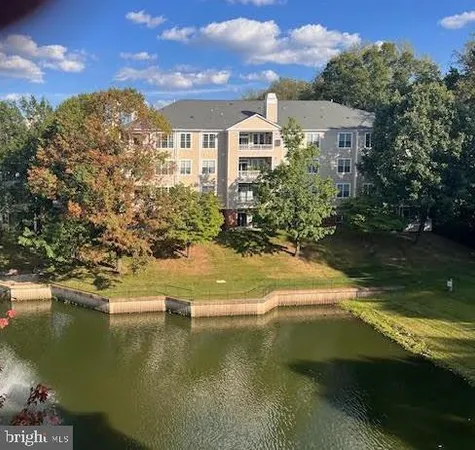 a view of residential houses with outdoor space and lake view