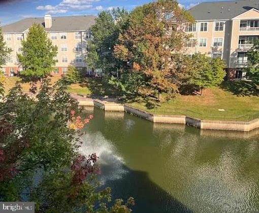 a view of residential houses with outdoor space and lake view