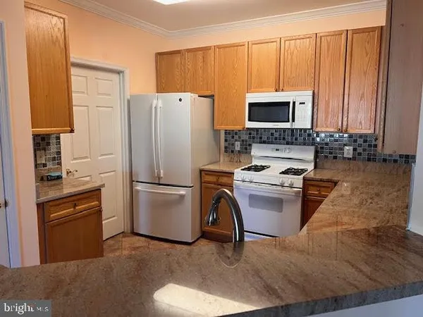 a kitchen with a refrigerator stove and microwave