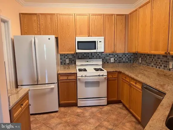 a kitchen with a refrigerator sink and microwave