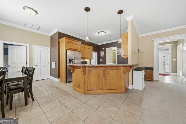 a view of kitchen with furniture and refrigerator