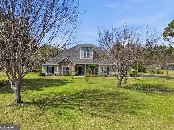a front view of a house with a yard