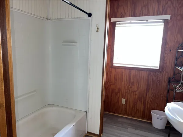 a bathroom with a tub and shower