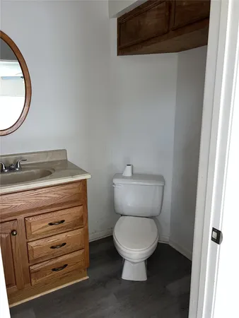 a bathroom with a toilet a sink and a mirror